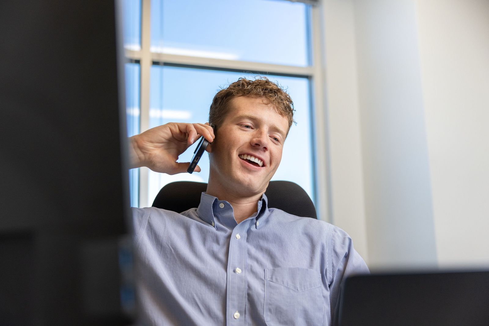 Matthew laughing on a call with a client